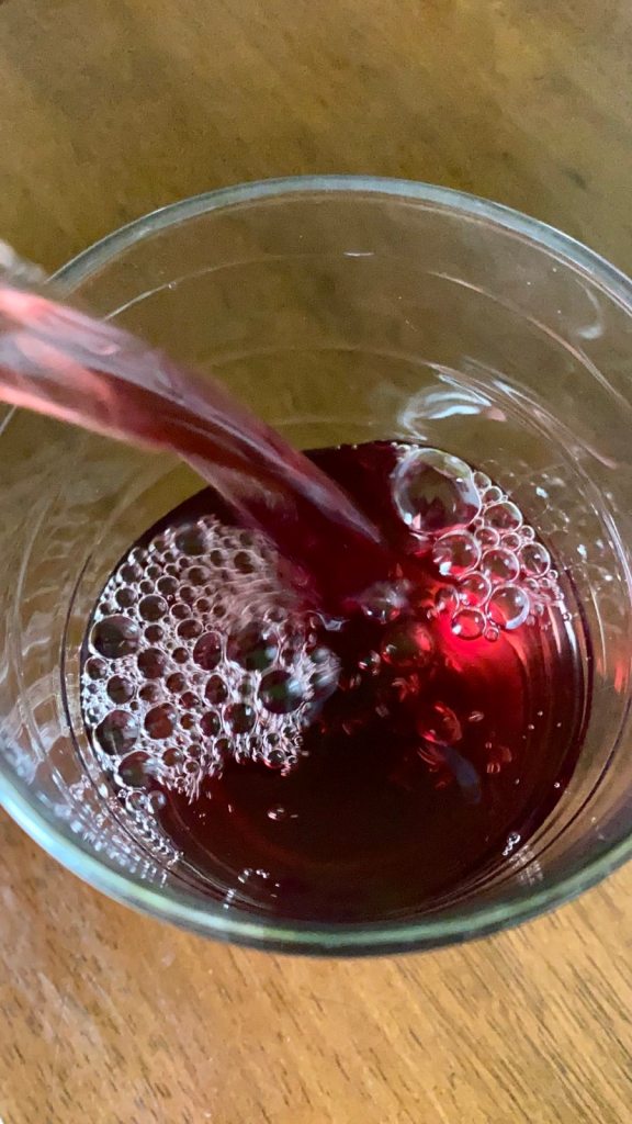 Pouring Tipco pomegranate juice to a glass