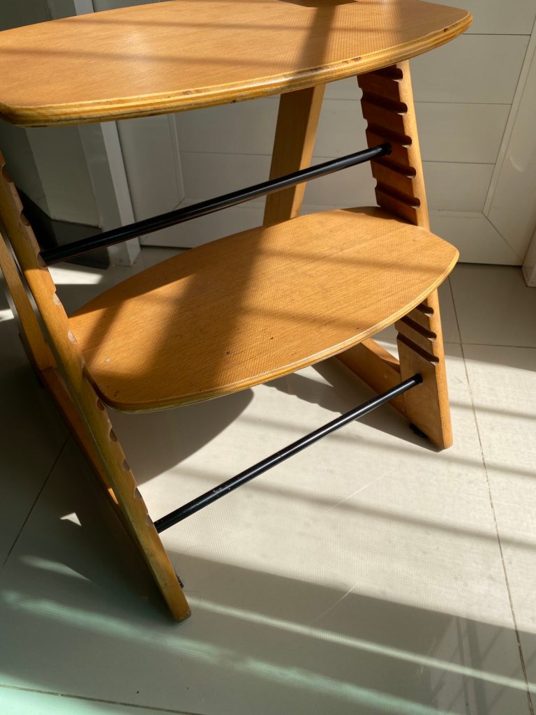 A Japanese high chair features fully adjustable seat and foot rest, as well as detachable lock and table.