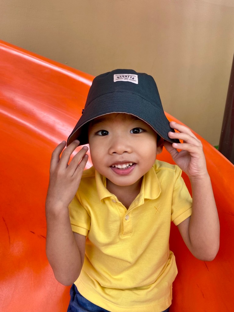 Smiling little boy wearing a bucket hat