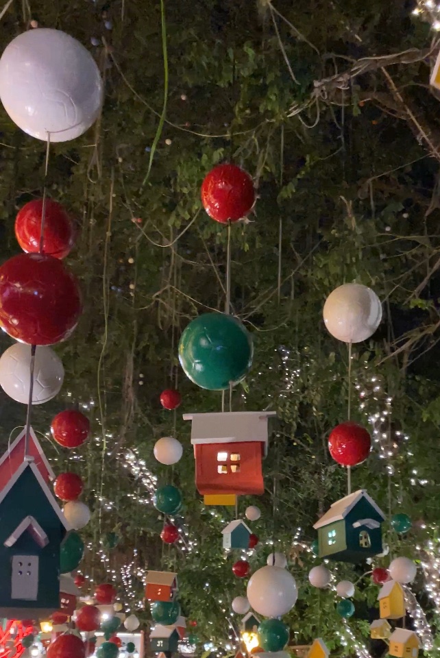 House ornaments hanging from a tree