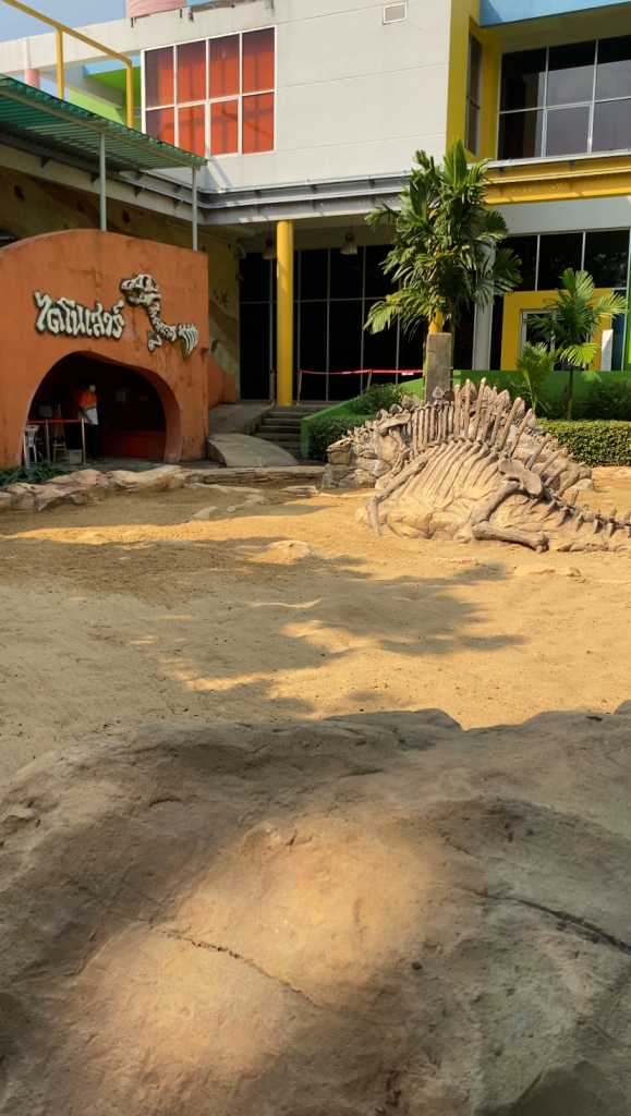 Sandbox with artificial dinosaur bones